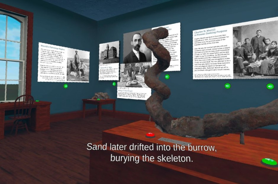 A view into a museum room with various images and text descriptions. A caption reads "Sand later drifted into the burrow, burying the skeleton."